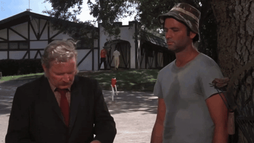 Two Men Standing Next To Each Other With Correct Me If I 'M Wrong Sandy Above Them GIF