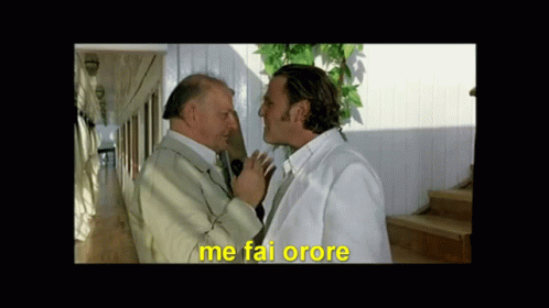 Two Men Standing Next To Each Other With Me Fai Orore In Yellow GIF