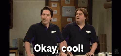 Two Men Standing Next To Each Other With Okay Cool Written On The Screen GIF