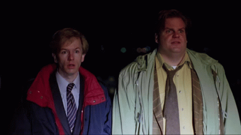Two Men Standing Next To Each Other With One Wearing A Yellow Shirt And Tie GIF