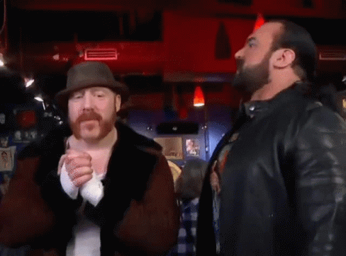 Two Men Standing Next To Each Other With The Word Banger On The Bottom Right GIF