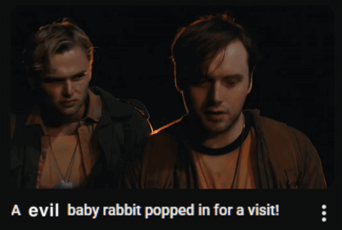 Two Men Standing Next To Each Other With The Words A Evil Baby Rabbit Popped In For A Visit On The Bottom GIF