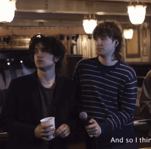 Two Men Standing Next To Each Other With The Words " And So I Thin " On The Bottom Right GIF