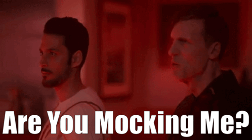 Two Men Standing Next To Each Other With The Words " Are You Mocking Me " On The Bottom GIF
