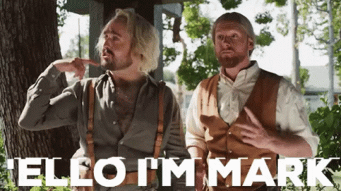 Two Men Standing Next To Each Other With The Words " Hello I 'M Mark " Written In White GIF
