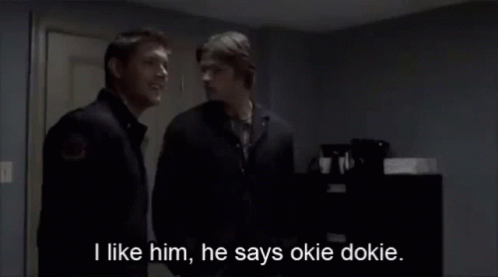 Two Men Standing Next To Each Other With The Words I Like Him He Says Okie Dokie GIF