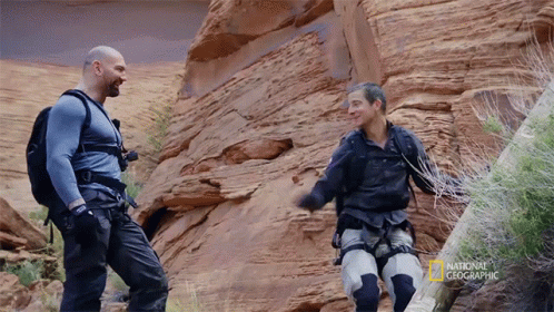 Two Men Standing Next To Each Other With The Words National Geographic On The Bottom GIF