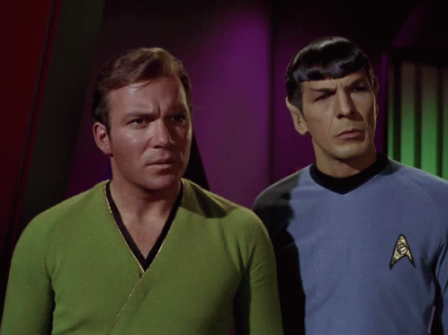 Two Men Standing Next To Each Other With The Words " The What " Written Above Them GIF