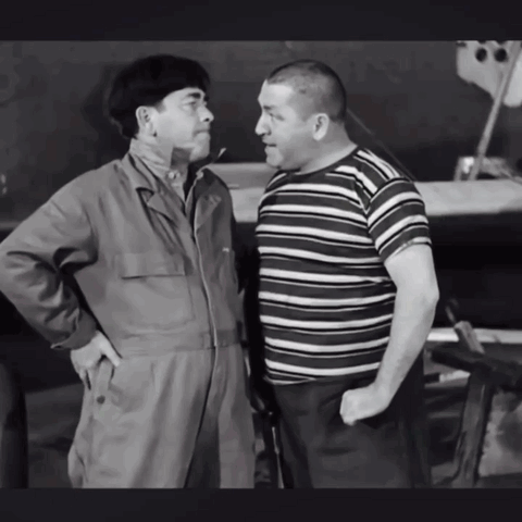 Two Men Standing Next To Each Other With Their Hands In Their Pockets GIF