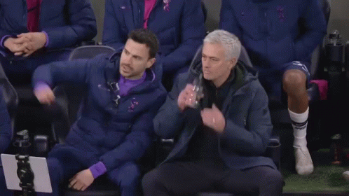 Two Men Standing on Soccer Field Talking
