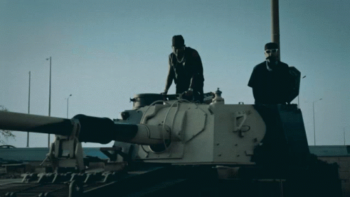 Two Men Standing on Tank Number 7