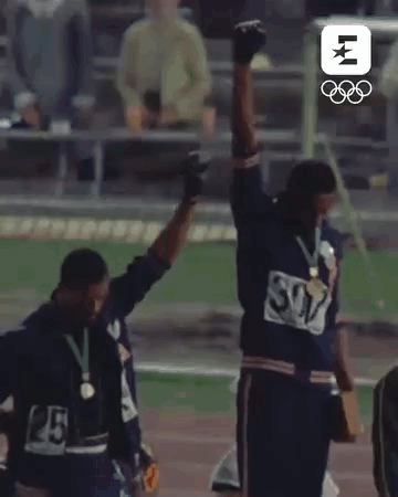 Two Men Standing On Track With Arms In Air GIF