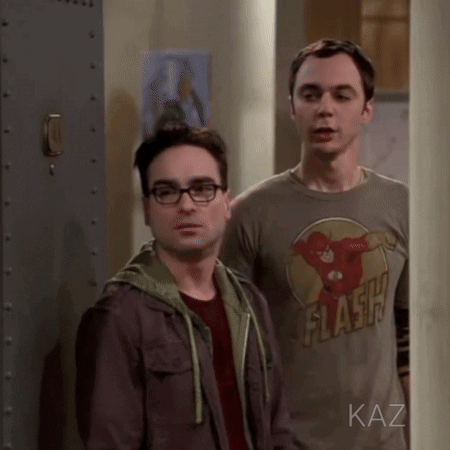 Two Men Standing, One Wearing Flash Shirt