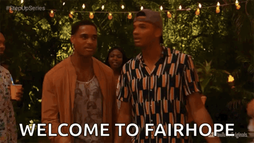 Two Men Standing With Welcome to Fairhope Text