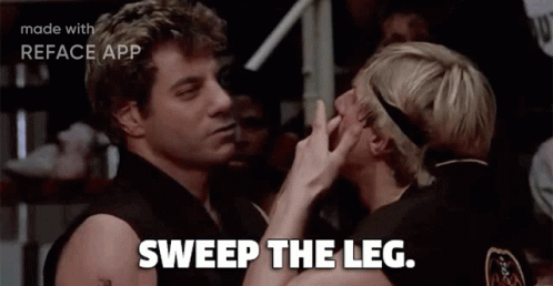 Two Men Sweep Each Other 'S Leg In A Movie Scene GIF