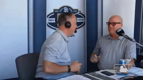 Two Men Talking at Microphone