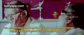 Two Men Talking At Table In Movie Scene GIF
