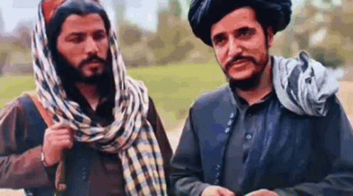 Two Men Talking in Field