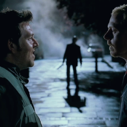 Two Men Talking in Front of Man Silhouette