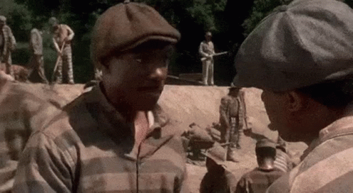 Two Men Talking in Prison Yard