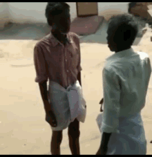 Two Men Talking In Sand GIF