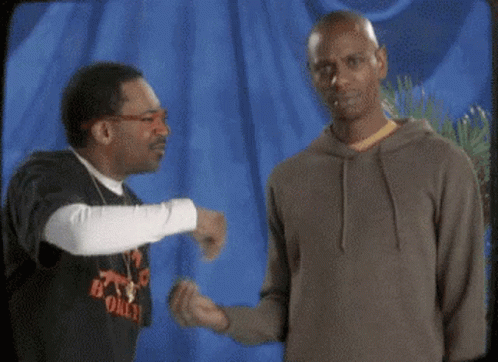 Two Men Talking, One in B Only Shirt