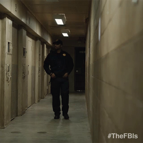 Two Men Walking Down A Hallway With #Thefbls On The Bottom GIF