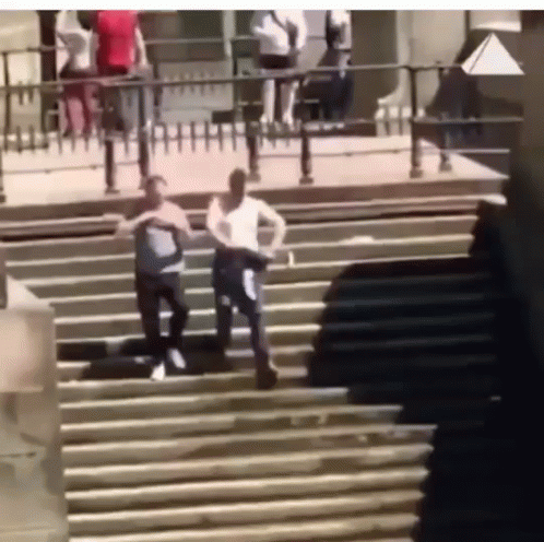 Two Men Walking Down Stairs With Fence