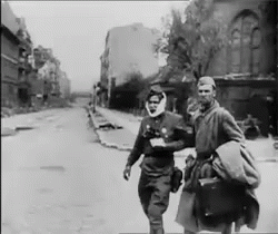 Two Men Walking Down Street