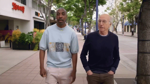 Two Men Walking Past Supreme Restaurant