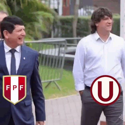 Two Men Walking: Suit and White Shirt With U