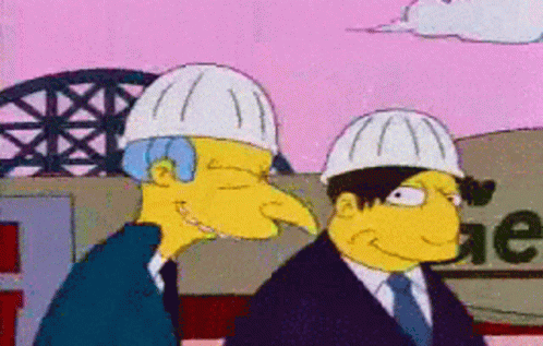 Two Men Wearing Hard Hats Are Standing Next To Each Other In Front Of A Sign That Says Ge GIF