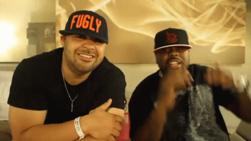 Two Men Wearing Hats One Says Fugly