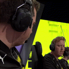 Two Men Wearing Headphones Are Sitting In Front Of A Yellow Screen . GIF