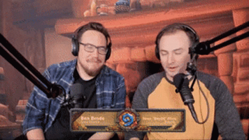 Two Men Wearing Headphones at Microphone