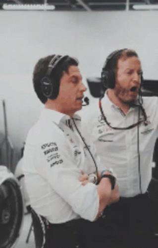 Two Men Wearing Mercedes Shirts and Headphones