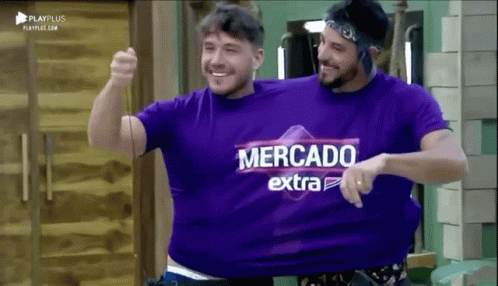 Two Men Wearing Purple Shirts That Say Mercado Extra Are Hugging Each Other GIF