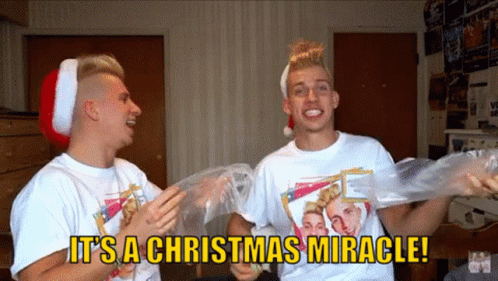 Two Men Wearing Santa Hats Are Holding Plastic Bags And Saying It Is A Christmas Miracle GIF