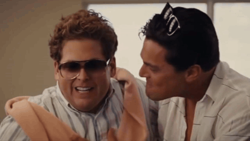 Two Men Wearing Sunglasses Are Talking To Each Other And One Has A Jack Daniels Hat On His Head GIF