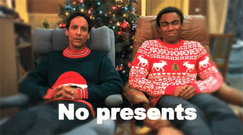 Two Men Wearing Ugly Christmas Sweaters Are Sitting In Front Of A Christmas Tree With The Words " No Presents " Written  GIF