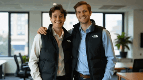 Two Men Wearing Vests That Say The North Face Are Posing For A Picture GIF
