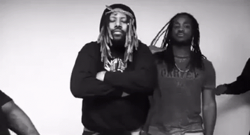 Two Men With Dreadlocks Standing With Arms Crossed GIF