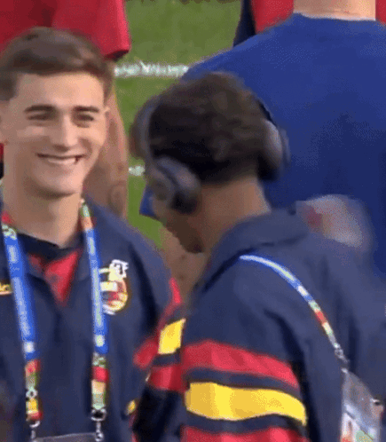 Two Men With Headphones Talking on Field