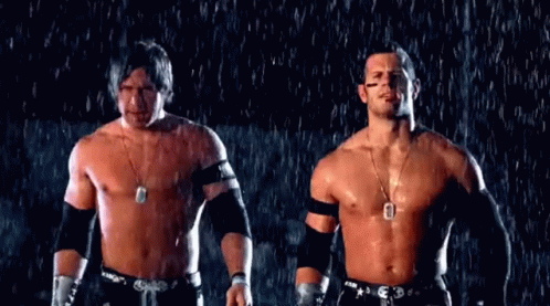 Two Men Without Shirts Are Standing In The Rain . GIF
