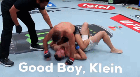 Two Men Wrestling In A Boxing Ring With The Words Good Boy Klein On The Bottom GIF