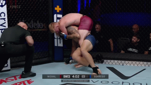 Two Men Wrestling in Cage Scoreboard DWCS