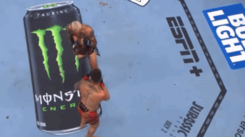 Two Men Wrestling in Front of Monster Energy Can
