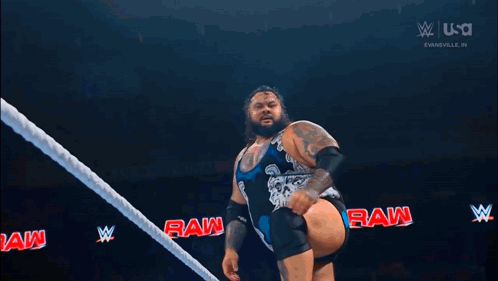 Two Men Wrestling in Ring With Crowd
