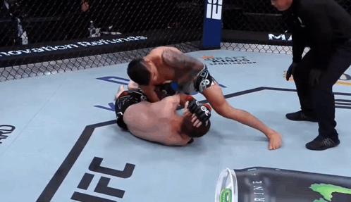 Two Men Wrestling In Ring With Monster Energy Drink