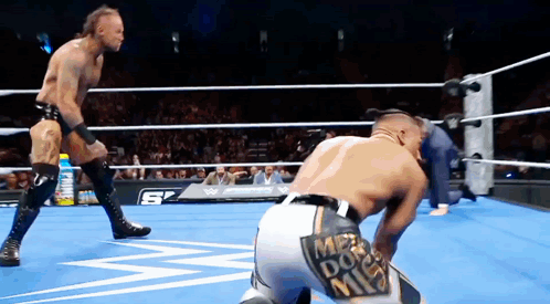 Two Men Wrestling In Ring With Mr. Do Me Patch GIF